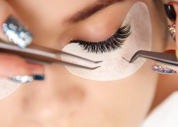Eyelash Extension Procedure. Woman Eye with Long Eyelashes. Lashes. Close up, macro, selective focus
